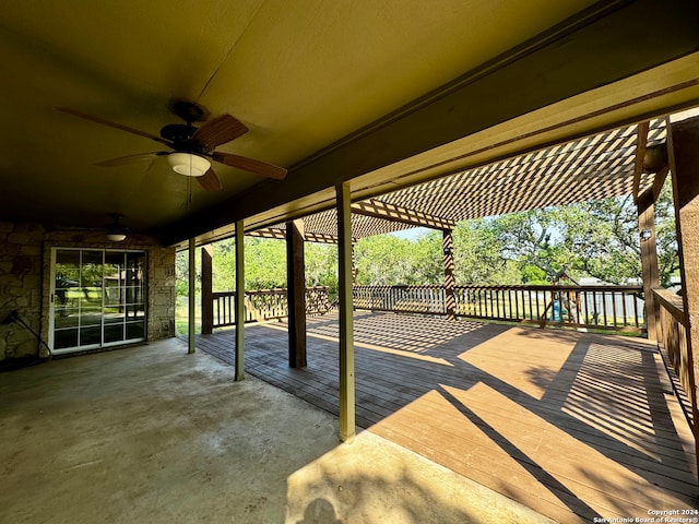 view of patio with ceiling fan and a deck