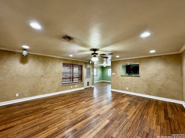 unfurnished living room with hardwood / wood-style floors, ceiling fan, and crown molding