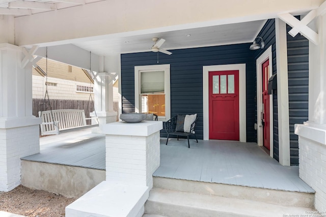 doorway to property with ceiling fan and a porch