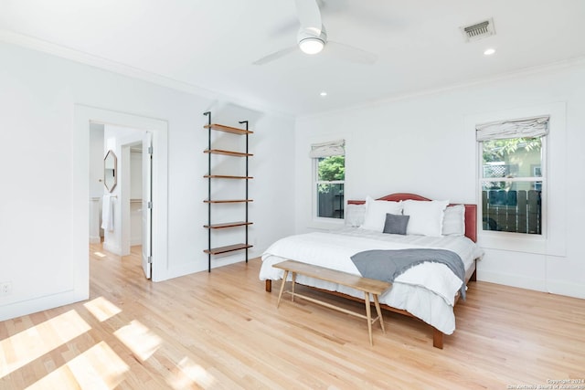 bedroom with light hardwood / wood-style flooring, ceiling fan, and ornamental molding