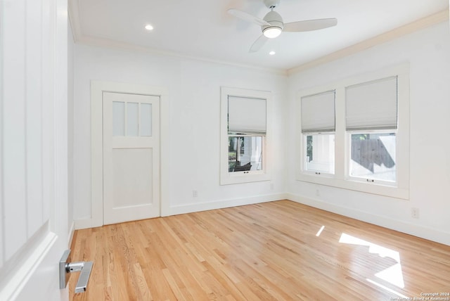 empty room with crown molding, ceiling fan, and light hardwood / wood-style floors