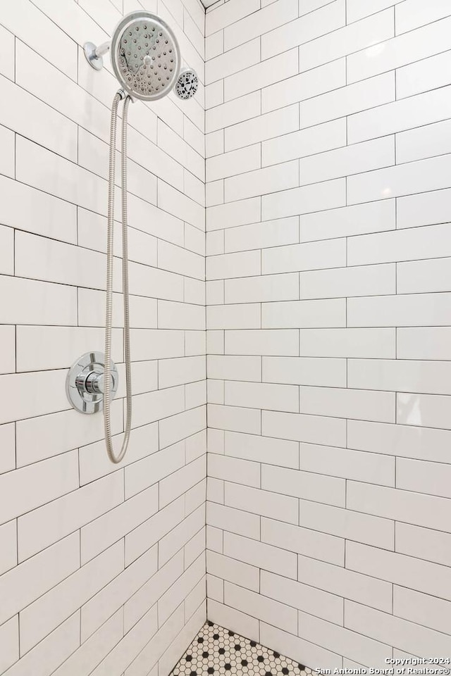 bathroom with a tile shower