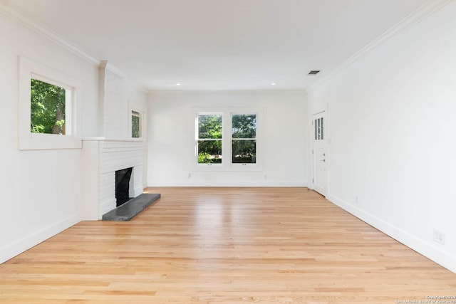 unfurnished living room featuring a fireplace, light wood-type flooring, and crown molding