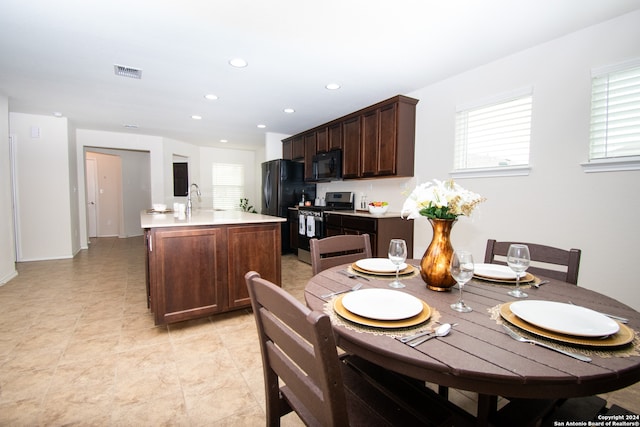 dining room featuring sink and light tile floors