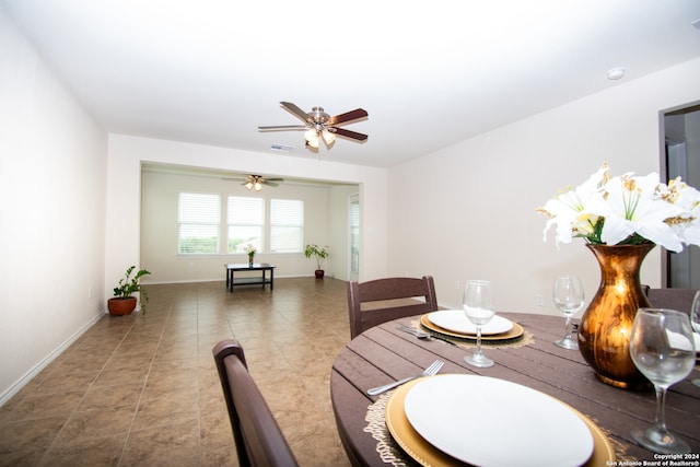 tiled dining area featuring ceiling fan