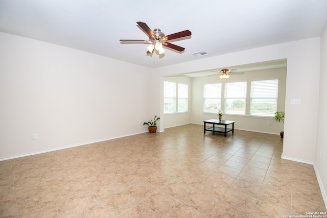 tiled spare room featuring ceiling fan