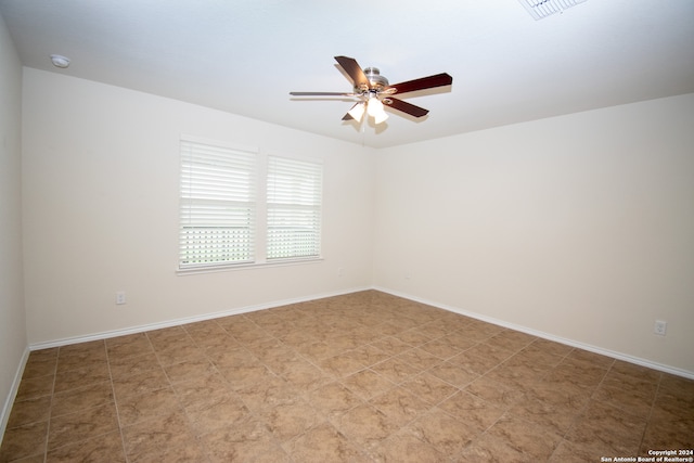 spare room with tile floors and ceiling fan