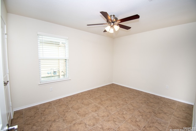 tiled spare room featuring ceiling fan