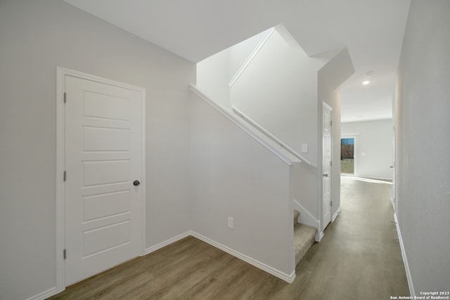 stairs with hardwood / wood-style flooring