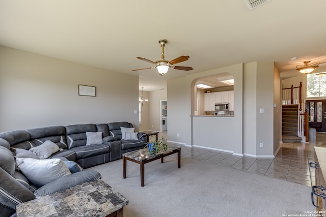 carpeted living room with ceiling fan