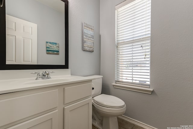 bathroom with oversized vanity, toilet, and tile floors