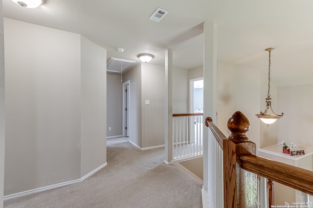 corridor with light colored carpet