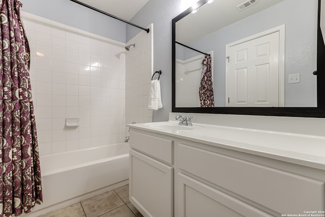 bathroom with shower / bath combo with shower curtain, vanity with extensive cabinet space, and tile floors