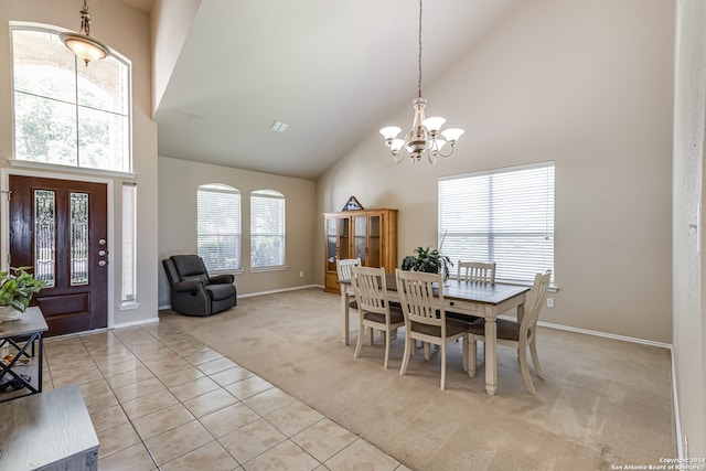 dining room featuring high vaulted ceiling, a notable chandelier, and light tile floors