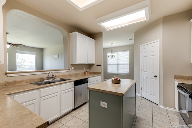 kitchen with a kitchen island, ceiling fan with notable chandelier, stainless steel dishwasher, white cabinets, and light tile flooring