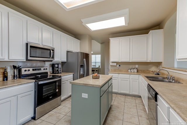 kitchen featuring light tile flooring, a kitchen island, stainless steel appliances, white cabinetry, and sink