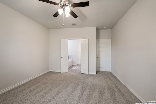 unfurnished bedroom with carpet flooring, visible vents, baseboards, and ensuite bathroom