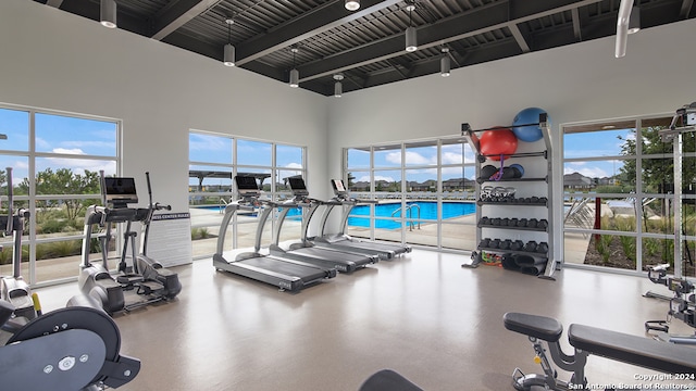 exercise room with a towering ceiling