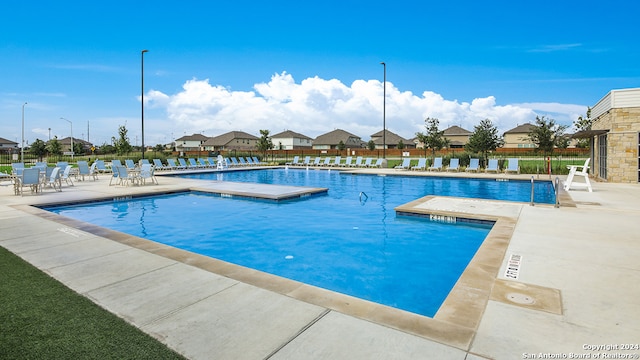 pool featuring a patio area and fence