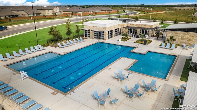 pool featuring a residential view, fence, and a patio