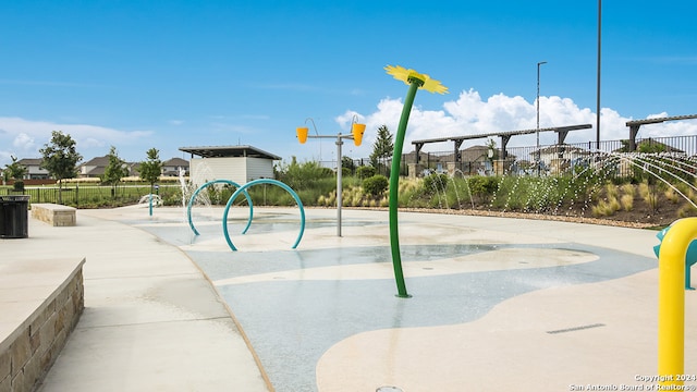 view of playground featuring fence