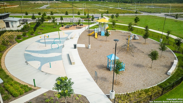 surrounding community featuring a lawn, fence, and playground community