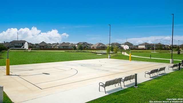 view of property's community featuring community basketball court, a lawn, and a residential view