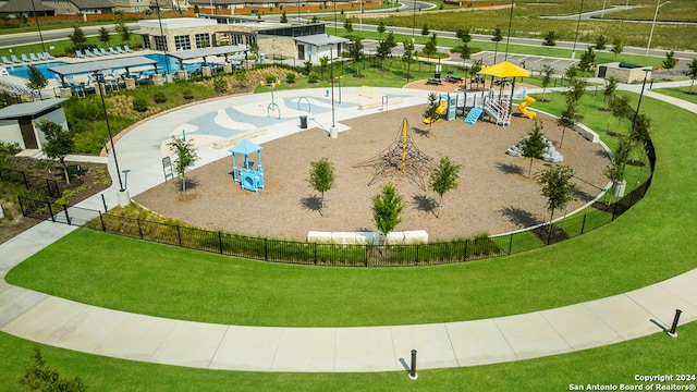 view of property's community featuring a playground and a yard