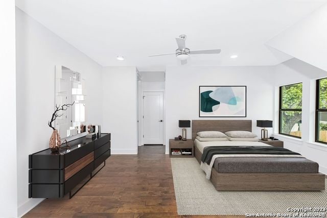 bedroom with ceiling fan and dark wood-type flooring