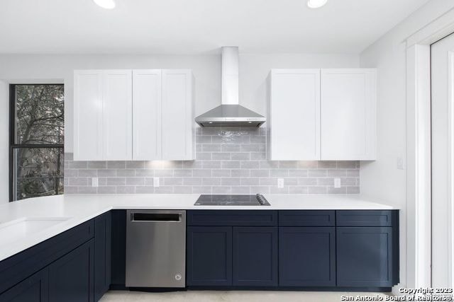 kitchen featuring dishwasher, white cabinets, black electric cooktop, and wall chimney exhaust hood