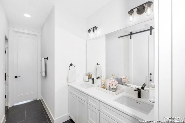 bathroom featuring dual vanity and tile floors