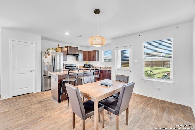 dining room with light hardwood / wood-style floors and sink