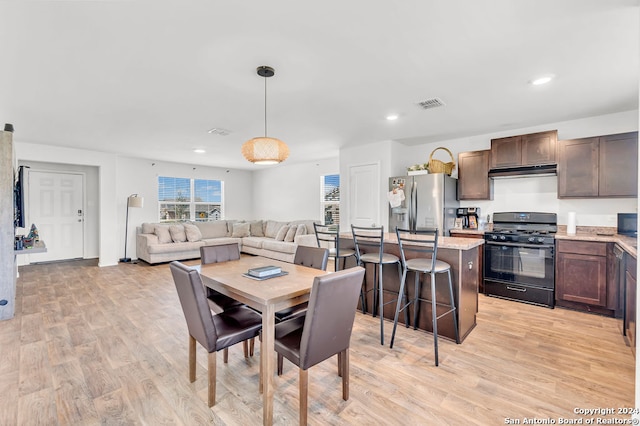 dining space with light wood-type flooring