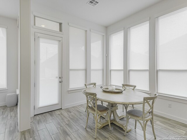 dining area with plenty of natural light and light hardwood / wood-style floors