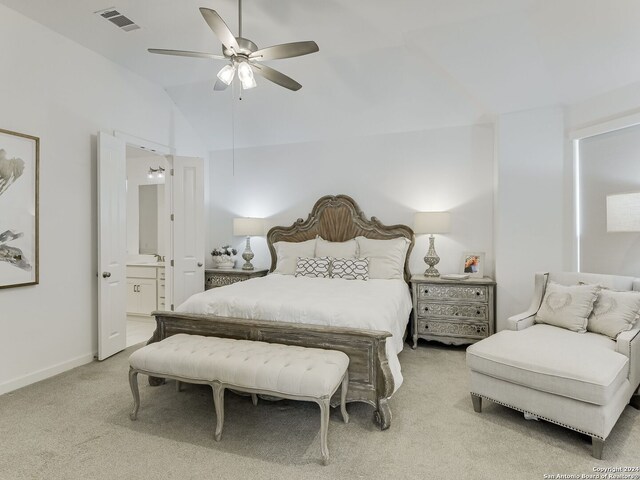 carpeted bedroom with lofted ceiling, ensuite bathroom, and ceiling fan