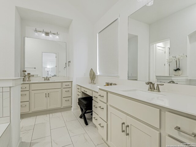 bathroom featuring oversized vanity, dual sinks, and tile floors