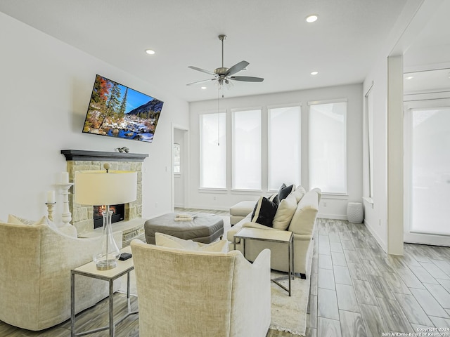 living room featuring ceiling fan and light hardwood / wood-style floors