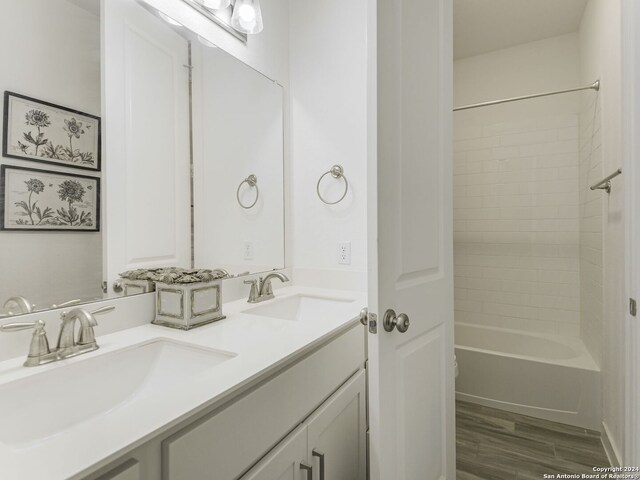 bathroom featuring shower / tub combination, oversized vanity, and double sink