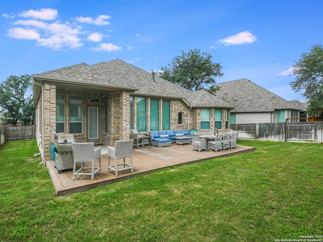 back of property featuring a wooden deck, an outdoor hangout area, and a yard