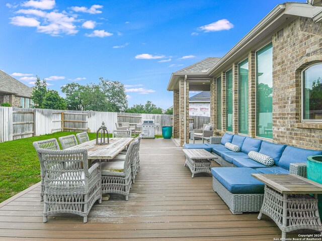 wooden terrace with an outdoor living space