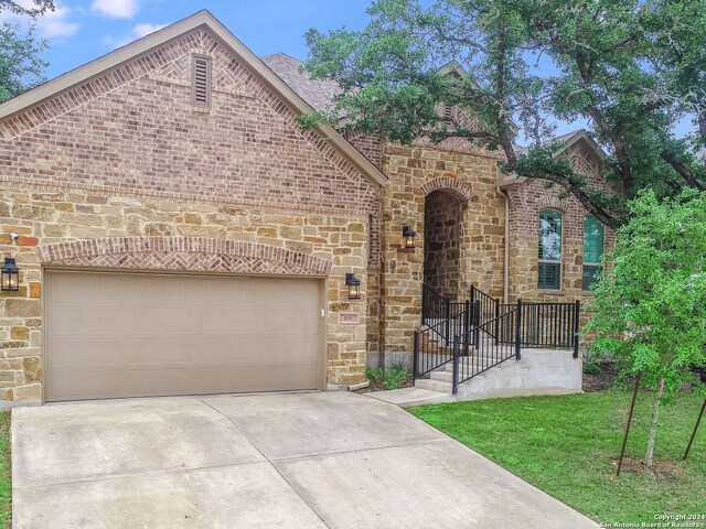 view of front facade with a front lawn and a garage