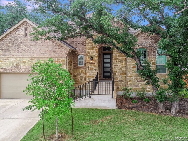 view of front of property featuring a garage and a front yard