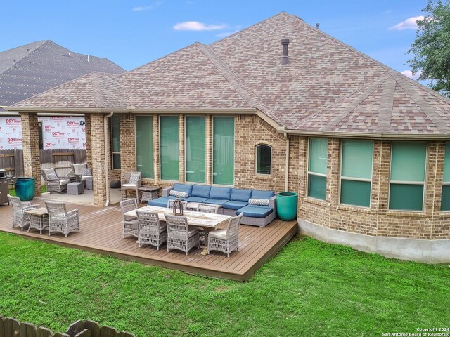 back of house with a yard, an outdoor living space, and a wooden deck