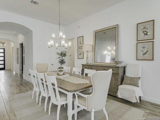 dining space featuring a chandelier and wood-type flooring