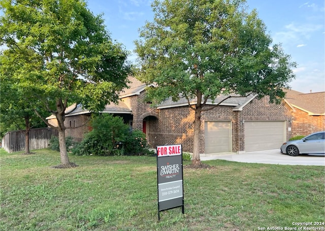 view of front of home featuring a garage and a front lawn