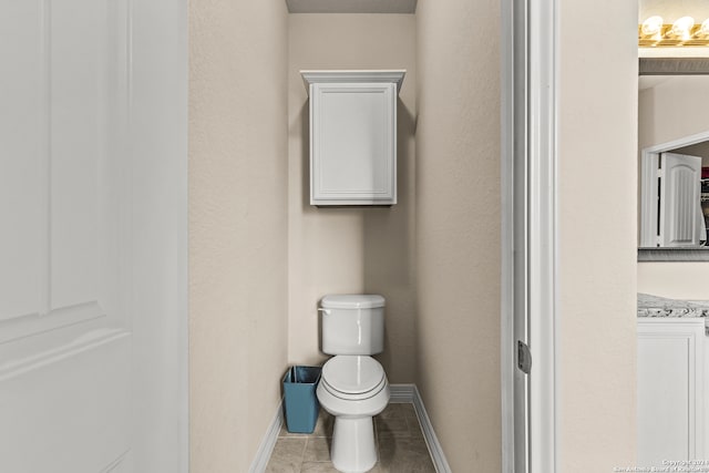 bathroom featuring vanity, toilet, and tile patterned flooring