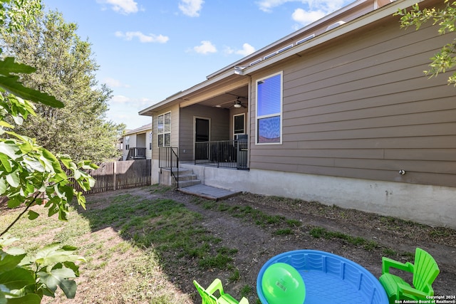 back of house with ceiling fan