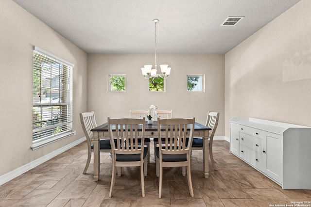 dining space featuring a chandelier