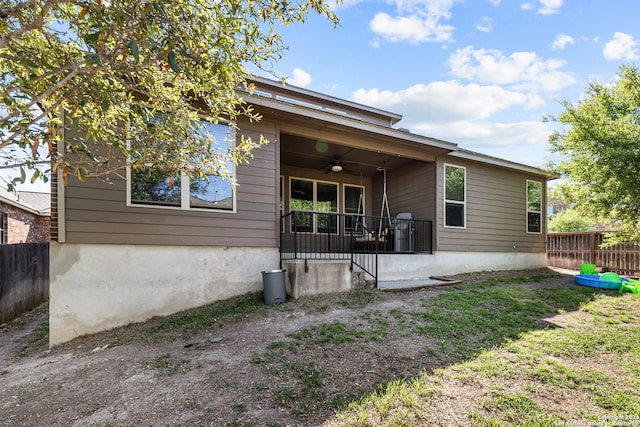 rear view of house with ceiling fan