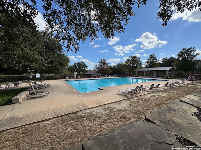 view of swimming pool featuring a patio area